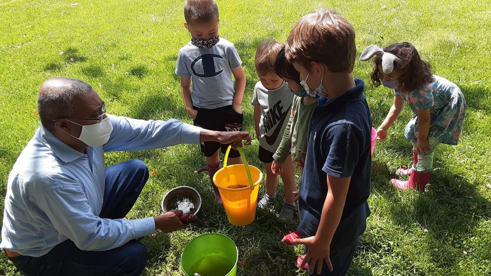Our MD working with children to use  chicken manure for fertilizing plants. This activity helps children make the interconnections amongst things around them.
